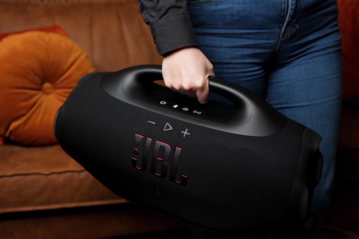 Persoon houdt de JBL Boombox 4 vast aan het handvat.