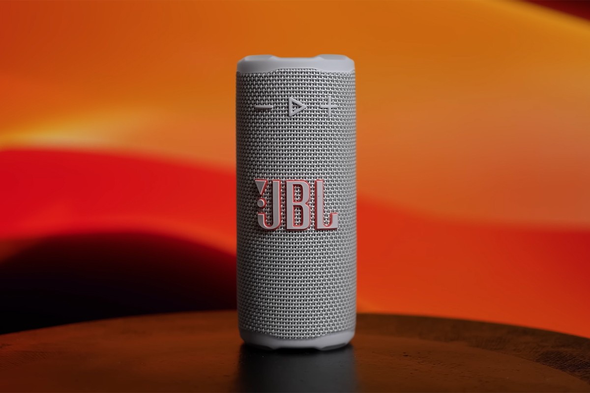 Close-up van de JBL Grip-speaker met oranje achtergrond