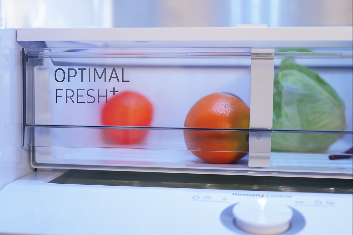 Close-up van de Optimal Fresh Plus lade gevuld met sinaasappelen en een krop sla.